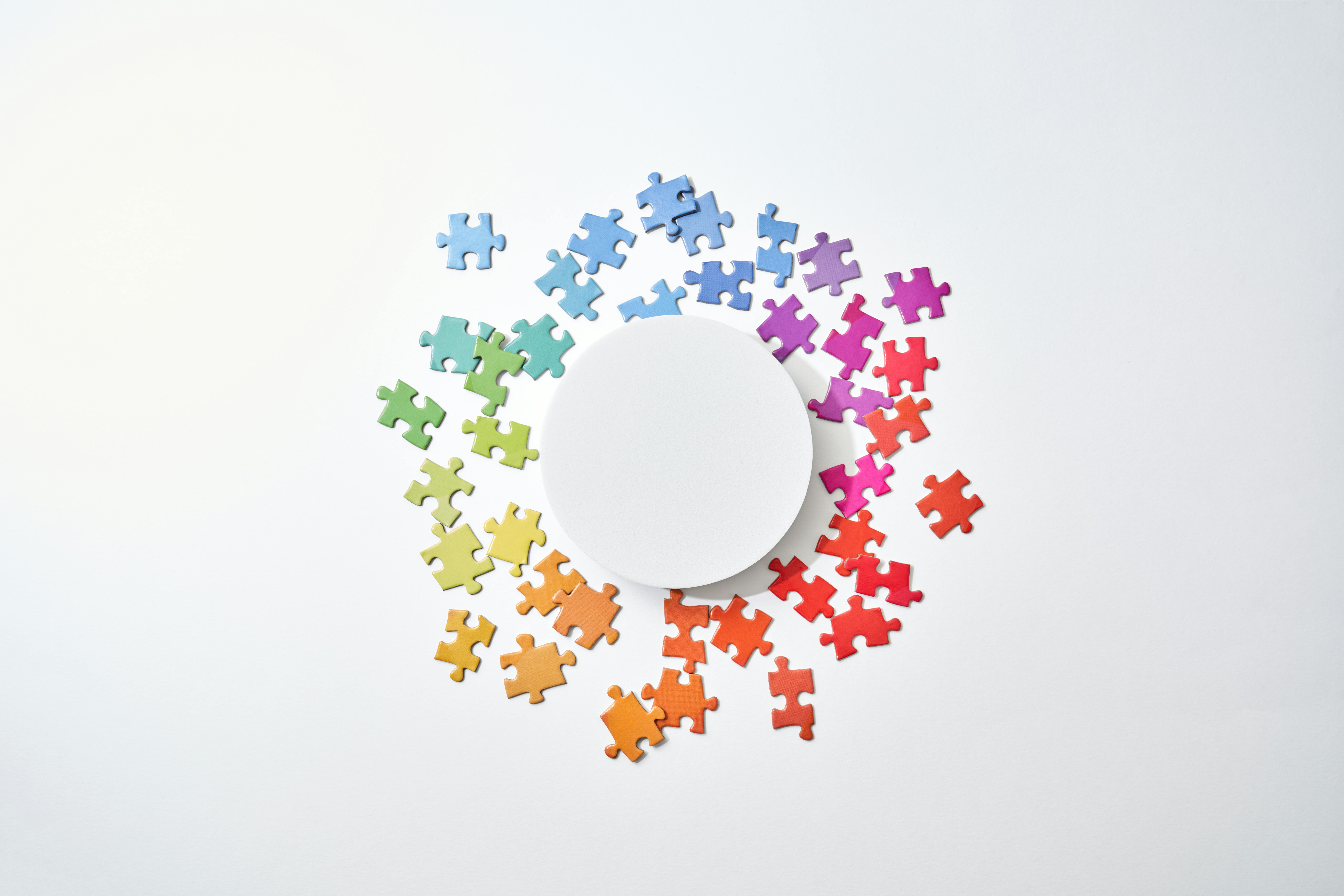 rainbow colored puzzle pieces on a white background