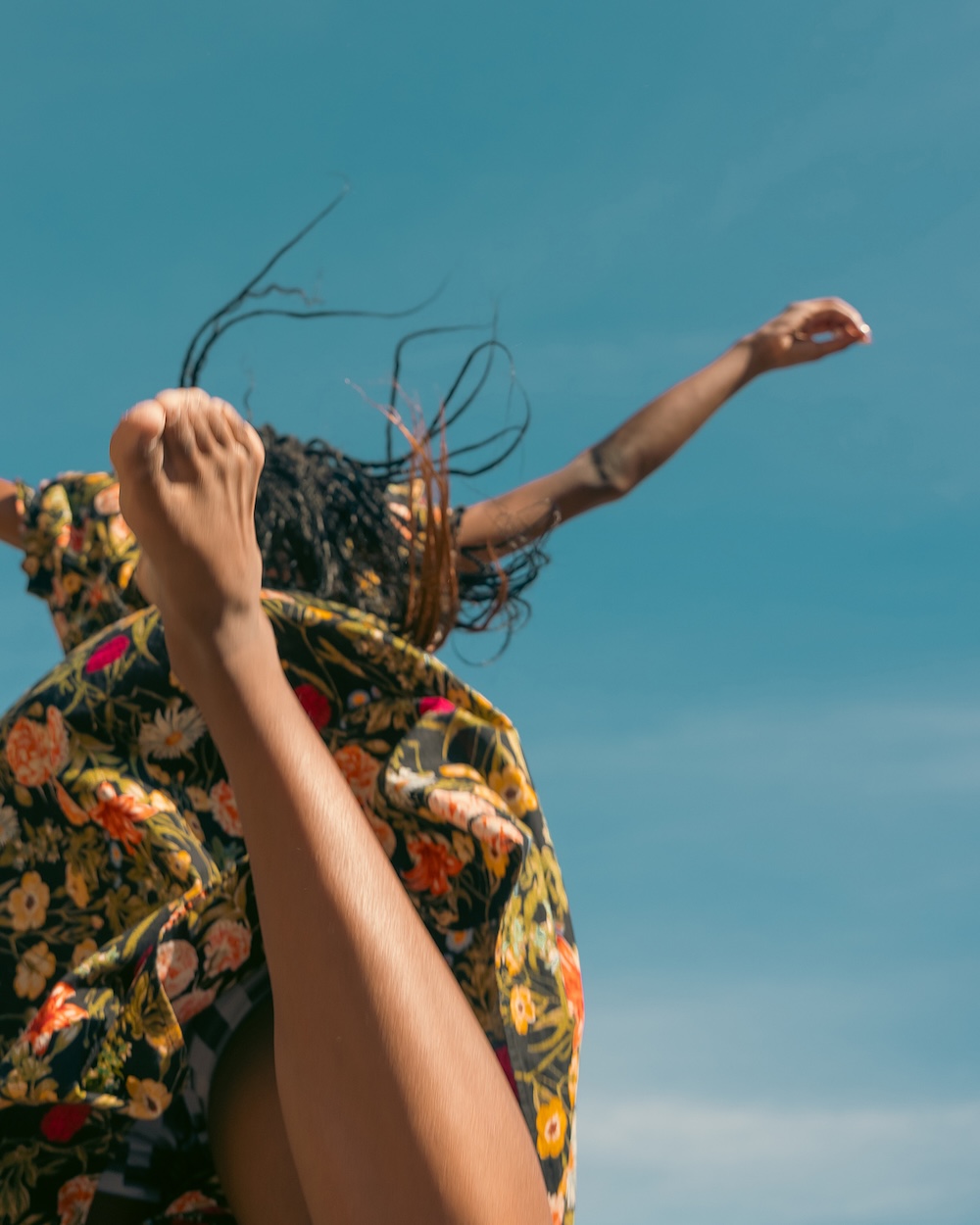 Woman leaping in the air viewed from below and behind