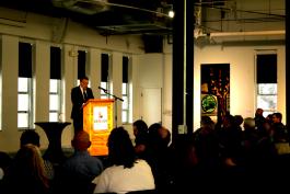 Photograph of award recipient Jim Kroll at a podium in front of an audience. 