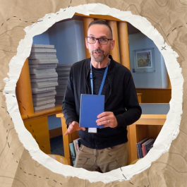 Photo of Special Collections and Archives librarian Brian showing off their collection. 