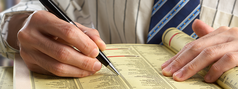 Businessman searching in yellow pages